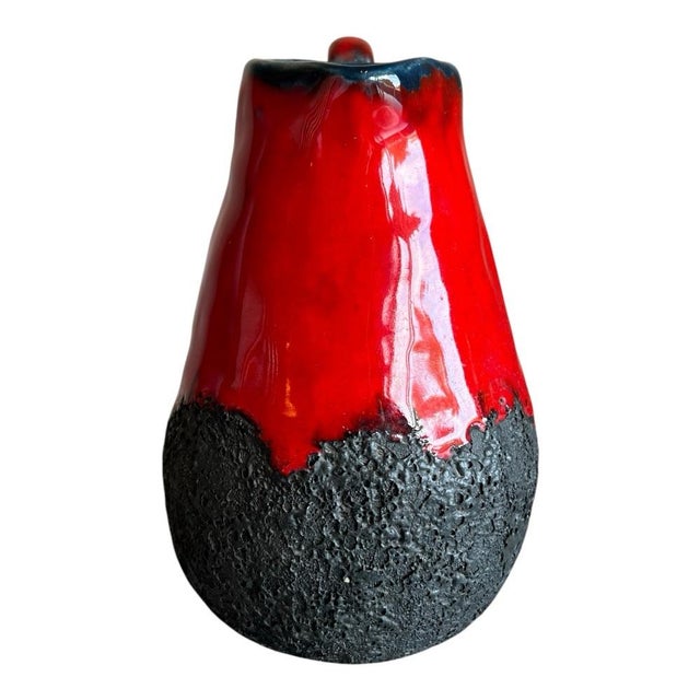 A striking West German studio pottery pitcher dating to the mid-20th century, featuring a vivid red high-gloss glaze...