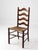 Vintage French Provincial ladderback chair featuring a warm walnut-toned finish, four gracefully shaped ladderback slats,...