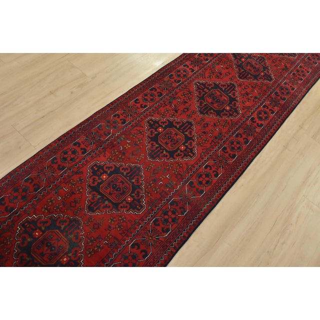 An authentic tribal Turkmen rug hand-knotted with fine wool and natural dyes. This nomadic rug features a row of geometric...