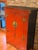 Beautiful Chinese-style cabinet finished in a rich red lacquer, featuring traditional brass hardware and double front...