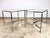 A pair of elegant, high-style, brass, chrome and glass Florentine side tables (unsigned) circa 1960’s. The tables feature...