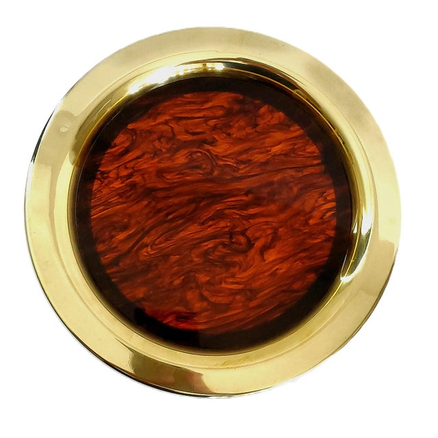 Offering a vintage brass and tortoise shell Lucite circular tray attributed to Christian Dior, circa 1970s. We chose to...