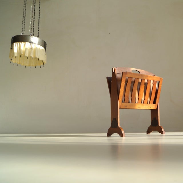 This generously scaled magazine stand, dating to around 1925, is a striking expression of the Dutch Amsterdam School...