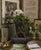 A striking hand‑painted black and gold chinoiserie metal vessel measuring 10” x 10” x 12.75” tall, this piece brings...