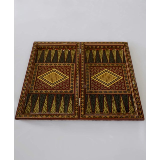 A one-of-one luxury chess and backgammon set crafted in Khatam marquetry, with a rich three-tone composition in black,...