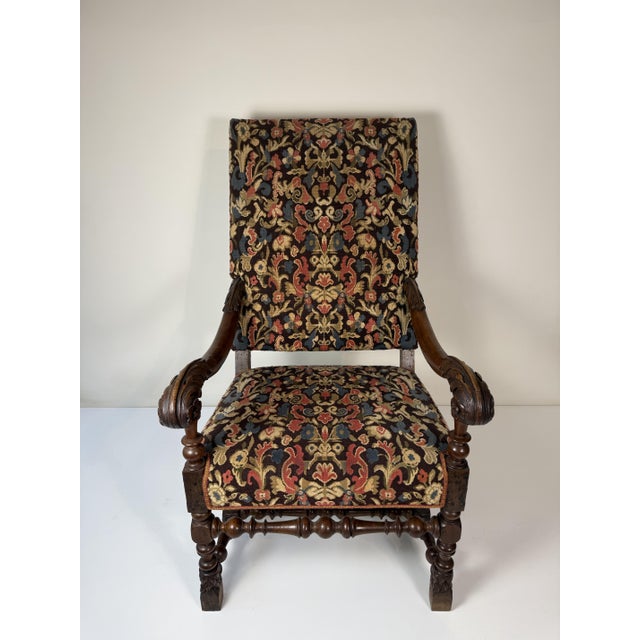 17th-century carved walnut armchair, Lombardy. This armchair features a high back and a spool structure, with legs and...