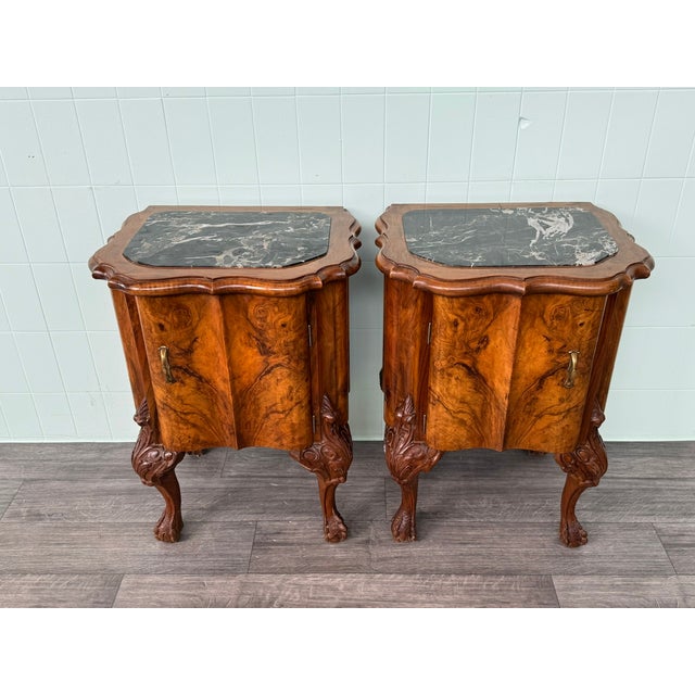 Pair of walnut bedside tables with finely crafted curved legs, embellished with elegant carvings and various details. The...