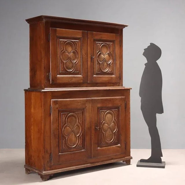 Baroque double-body sideboard in walnut, base and upper part with a pair of paneled doors with central carved cloverleaf...