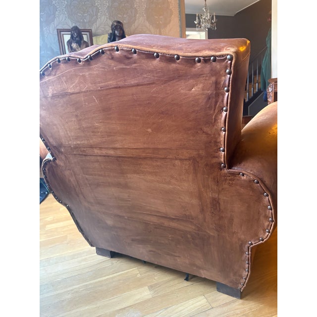 Beautiful and authentic pair of 1920s French Art Deco club chairs. Original hand-aged leather and generously proportioned...