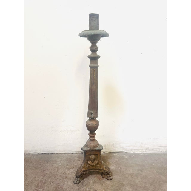 Antique Gothic-style or religious altar candlestick, likely constructed from cast brass or a similar dark metal. Design:...