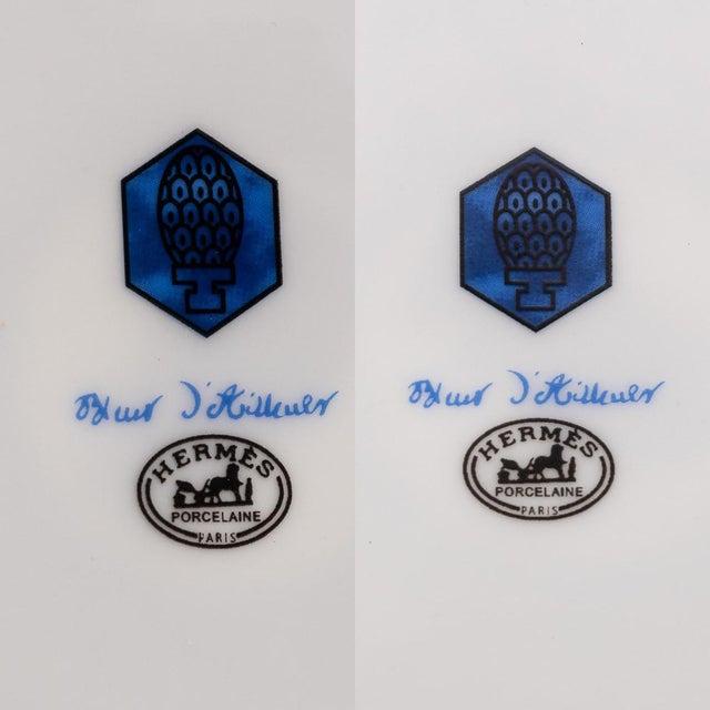 Hermès' Bleus d’Ailleurs pair of dessert plates, crafted in France from blue and white porcelain, showcases a geometric...