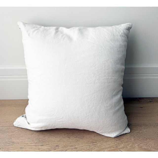 Large cotton pillow with black graphic design on front. Plain backing. Size: 24" sq Insert: Down feather pillow insert...