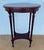 French mid-20th-century oak side table with an elegant oval top framed in wood, showcasing refined proportions and a...