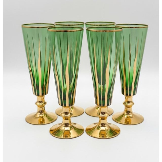 Set of 6 Murano-style hand-blown goblets in deep emerald glass, finished with 24k-style gold overlay on the stem, foot and...