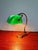 Articulated brass banker's lamp with a green opaline glass shade, 1920s-30s. Tension switch. Adjustable shade and tiltable...