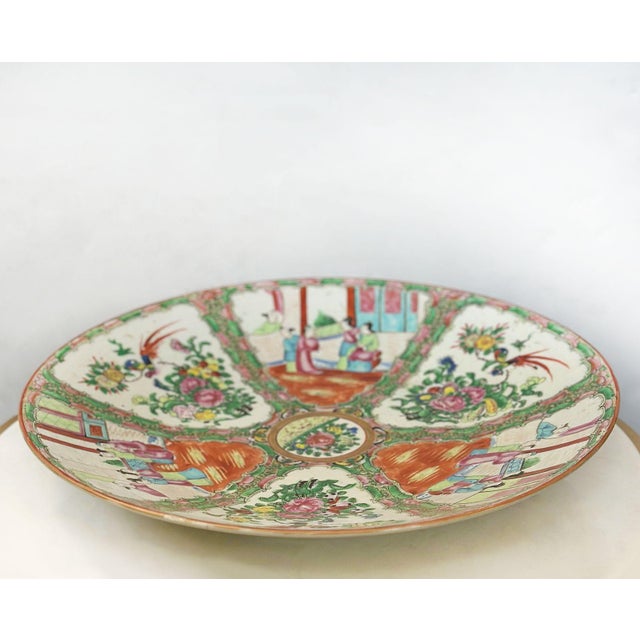 A beautiful and finely detailed Chinese Export Rose Canton charger plate, hand-painted in the early 19th century. This...