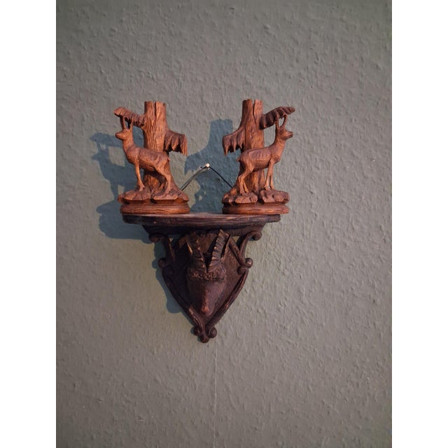 A set of three (3) pieces walnut wood with carved stags. A shelf with Stag head ,walnut wood. Two rare vase holders of...