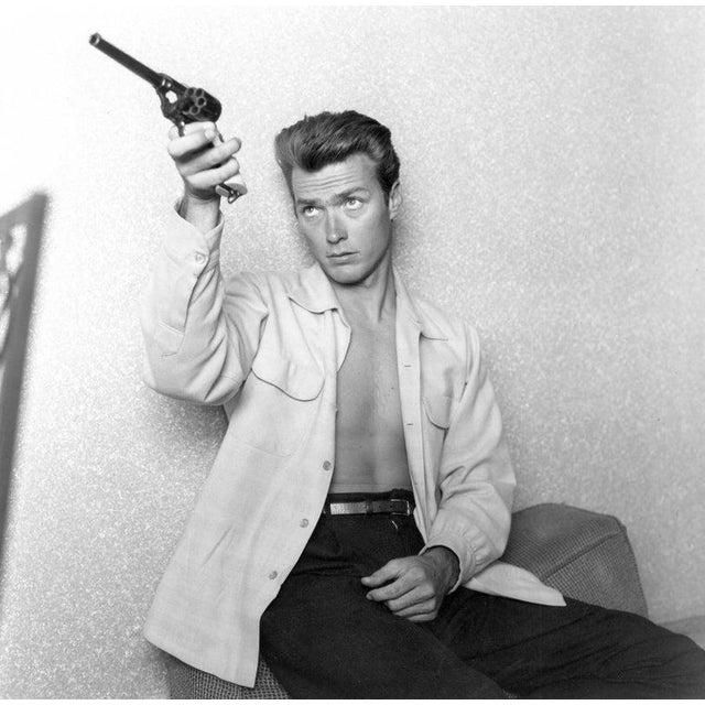 Clint Eastwood At Home LOS ANGELES - JUNE 1: Actor Clint Eastwood checks his gun at home on June 1, 1956 in Los Angeles,...