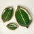 We love this set of three earthenware ceramic serving dishes in the Trompe L’Oeil style of banana leaves. They have a...