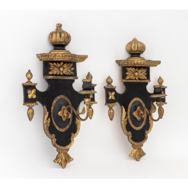 Pair of Neoclassical Style Ebonized and Gilt Composition Wall Sconces, each with a single candlestick arm. 21" H x 13.25"...
