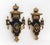 Pair of Neoclassical Style Ebonized and Gilt Composition Wall Sconces, each with a single candlestick arm. 21" H x 13.25"...