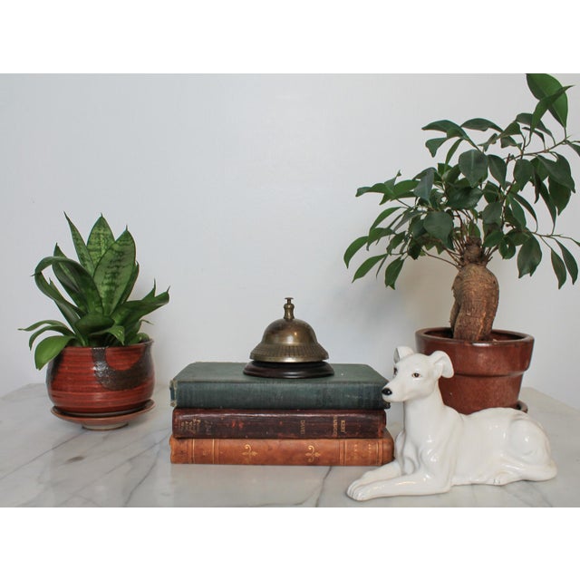 Vintage service or counter call bell made of solid brass dome with a dark wood base. No makers mark. Patina.