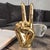 The Vintage Metallic Gold Coated Brass Peace Victory Hand Gesture sculpture is a unique and eye-catching piece of home...