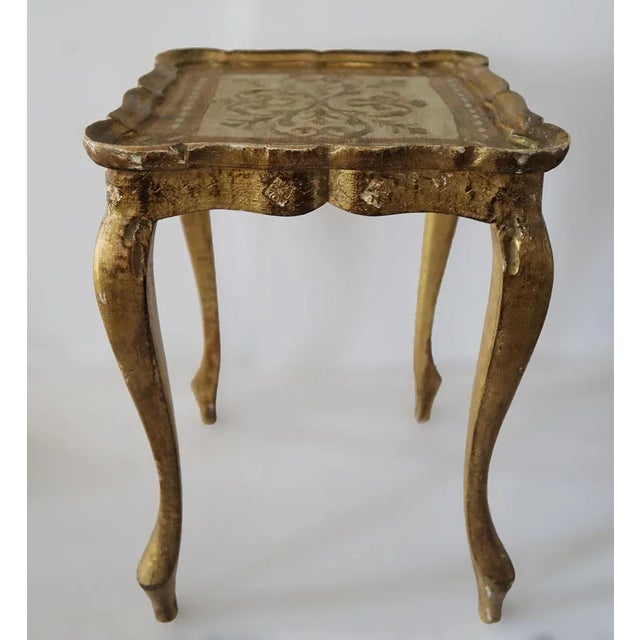 Mid century Florentine Renaissance style Italian nesting tables. Hand painted gold and ivory. Dimensions:Large:W:22' x...