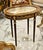Showcase your treasured collectibles in timeless French elegance with this exquisite Louis XVI oval display side table....