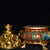 Ornate cloisonne enamel tripod censer decorated with vibrant red and turquoise enamel panels, accented by gold scrollwork...