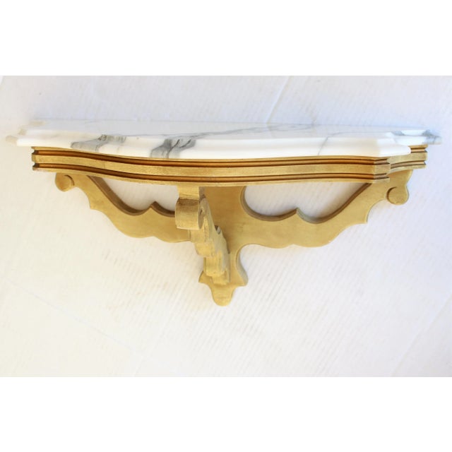 Superb antique Italian gilded wall shelf, with timelessly elegant carved polished porcelain surface. Made in Italy Wall...