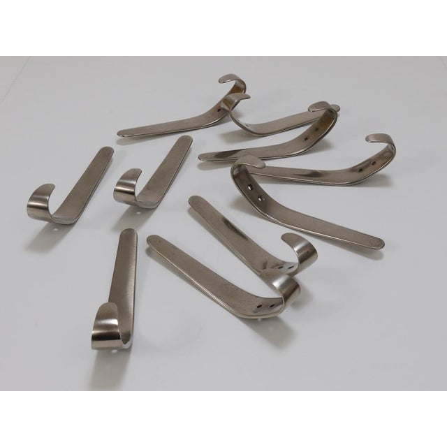 Up to 10 Midcentury brass wall hooks, model 4330, designed and executed in the 1950s by Carl Aubock II in Vienna, Austria....