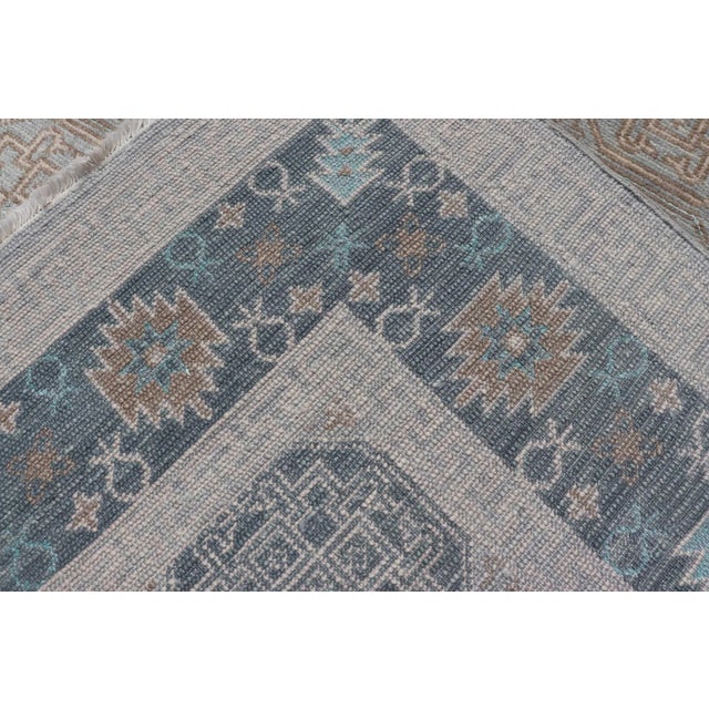 Modern Hand Knotted Khotan in Wool With All-Over Medallion Design in Blue and Earthy Tones For Sale - Image 12 of 13