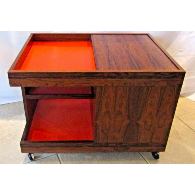 The MCM Swedish Rosewood Rolling Bar Cart Cabinet by Artie circa 1960s is a stylish and functional piece of furniture...