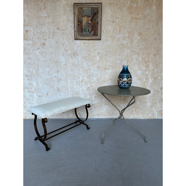 A vintage 1950s Spanish gilt iron bench with an elegant lyre-form base and hand-forged construction. The design features...