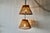 Vintage pair of handwoven bamboo and rattan pendant lamps featuring a tapered conical shade design with vertical slats....