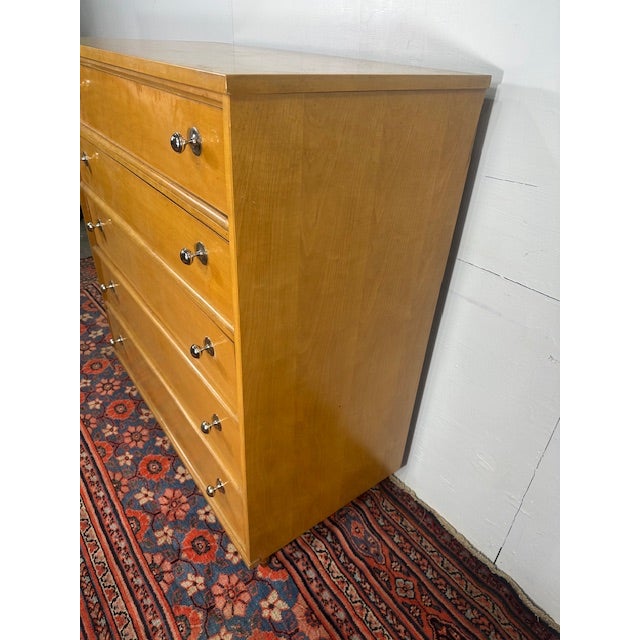 The Vintage Mid-Century 5-Drawer Light Tone Chest of Drawers is a sleek and functional piece that encapsulates the iconic...