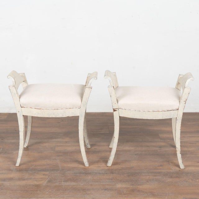 This lovely pair of Swedish pine stools or tabourets have gently curved, saber legs which add an elegant touch to the...