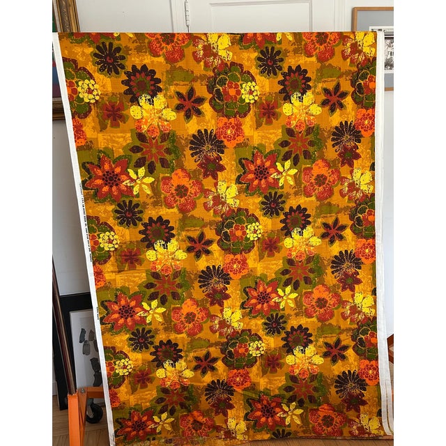 This is a 60s/70s mid-century heavy cotton barkcloth fabric featuring a bold marigold, orange, and earth-toned flower...