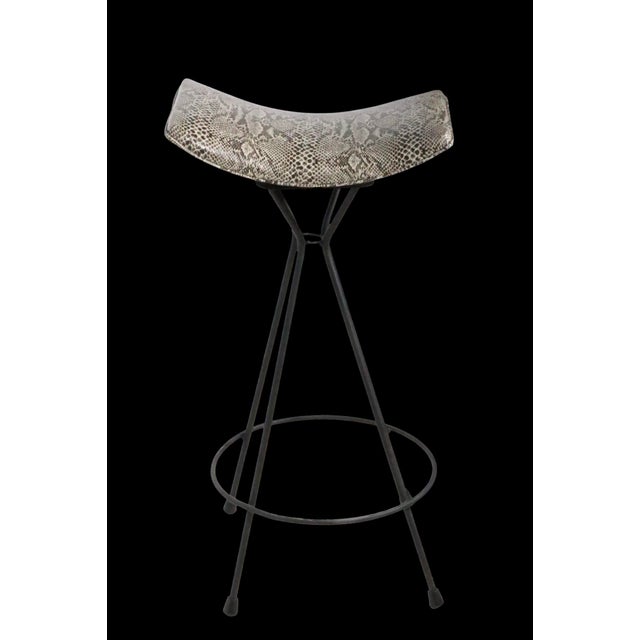 Set of three unusual mid century bar height swivel stools. The stools feature dramatic curved seats, newly reupholstered...