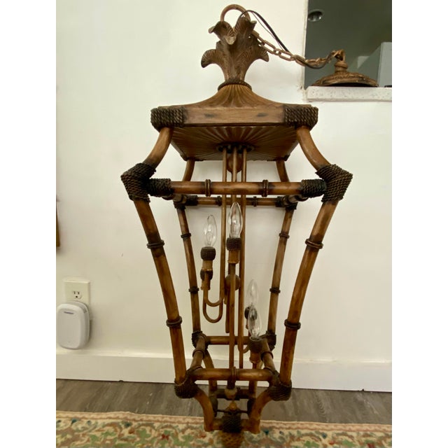 This vintage pagoda hanging lantern features an open, multi-tiered framework crafted in a faux-bamboo and rattan style....