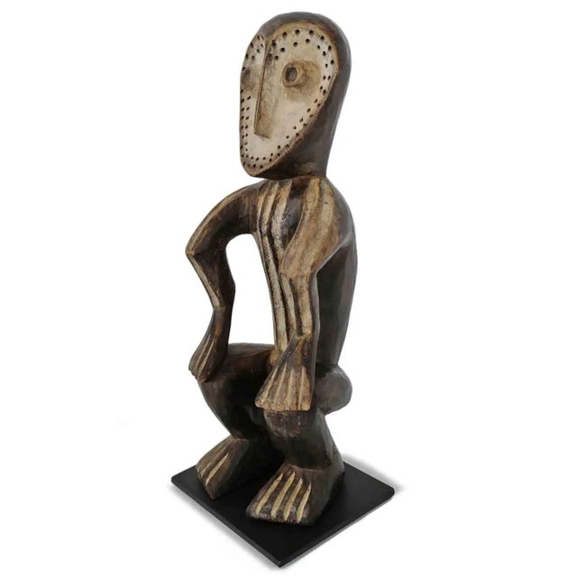 Old Lega figure from the eastern Democratic Republic of the Congo. This expressive piece embodies the refined abstraction...
