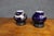 Pair of Japanese porcelain vases featuring deep cobalt blue grounds with applied copper-overlay decoration depicting...
