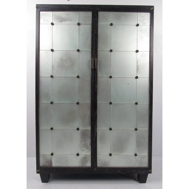 Unique frosted glass-front two-door cabinet with three internal shelves and ample space to house multiple electronic...