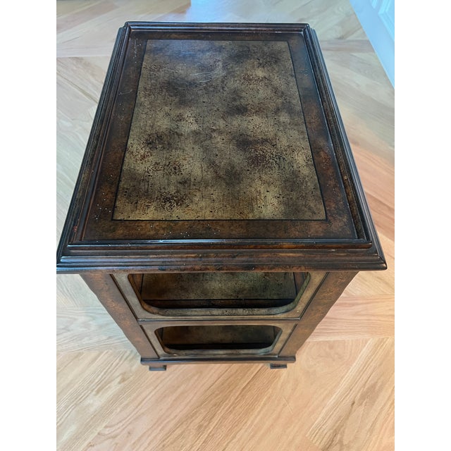 Distinctive vintage three-tier accent table by Milling Road / Baker Furniture. Features an unusual antiqued, mottled brown...