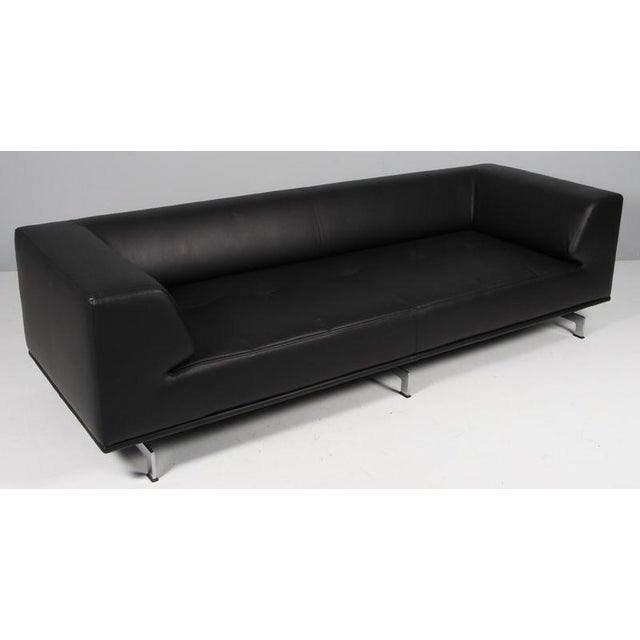 Hannes Wettstein three seat sofa new upholstered with black elegance full grain aniline leather. Base of brushed steel....
