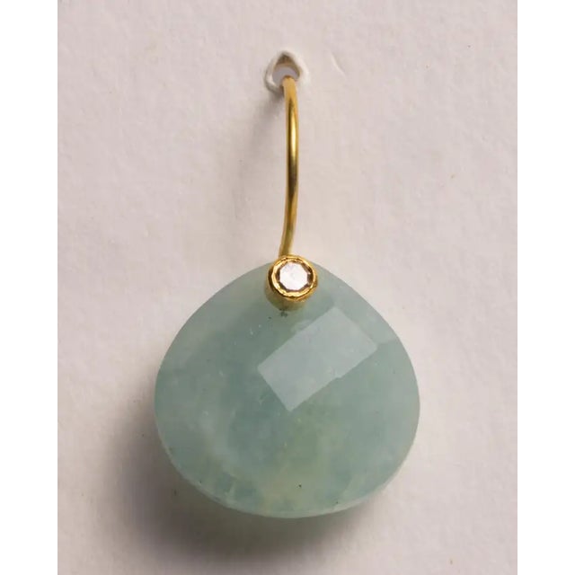A pair of classic, heart-shaped rose cut aquamarine drop earrings with a single, round faceted diamond at the top. 18K...