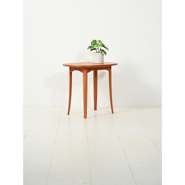 Teak coffee table, model "Ovalen," designed by Carl Malmsten, with original manufacturer's label. Teak coffee table, model...