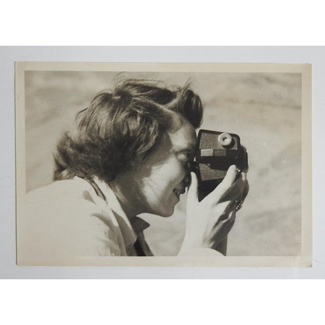 Mid 20th century sepia tone snapshot photograph on paper of woman photographer with camera. Unframed, corner bumps.