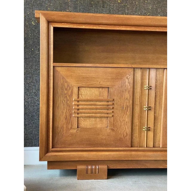 Uniquely scaled and handsome oak cabinet by Charles Dudouyt on solid block feet. Two hinged doors on left and right side...